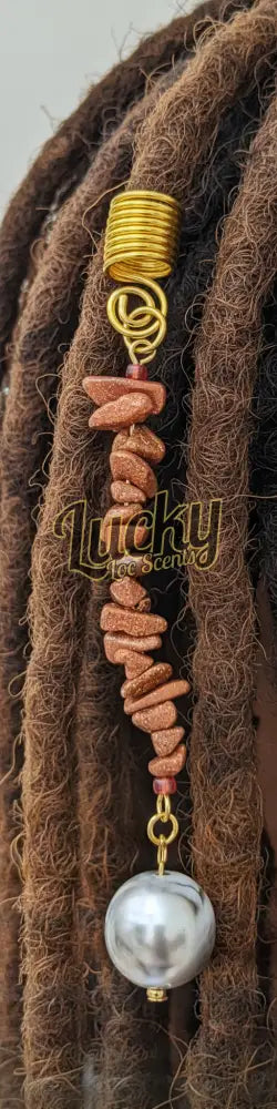 Decorative beaded charm with gold clasp and beads on a string