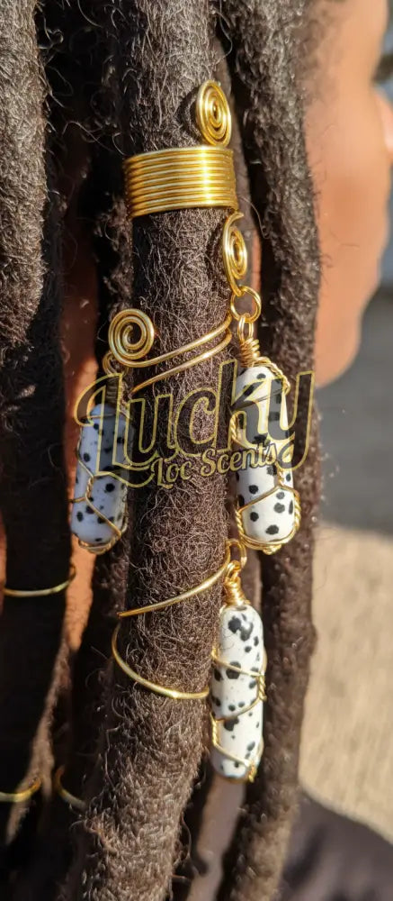 Decorative black spotted pendant with gold clasp