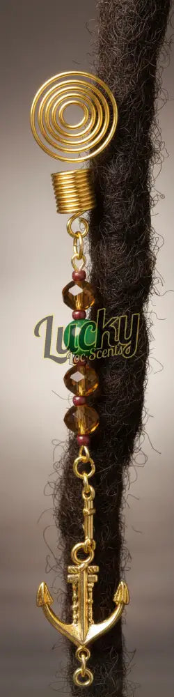 Decorative hair accessory with anchor, beads, and spiral design at top.